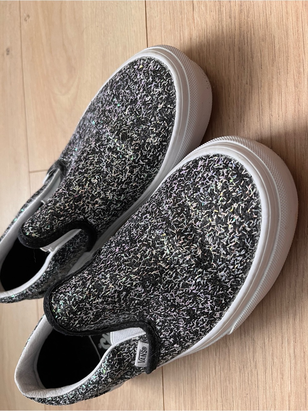 Vans Classic Slip-On sneakers in the "Shiny Party" black and glitter